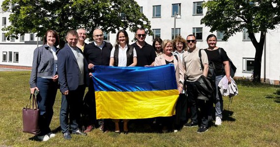 Gruppfoto framför Södersjukhuset med Ukrainas flagga.