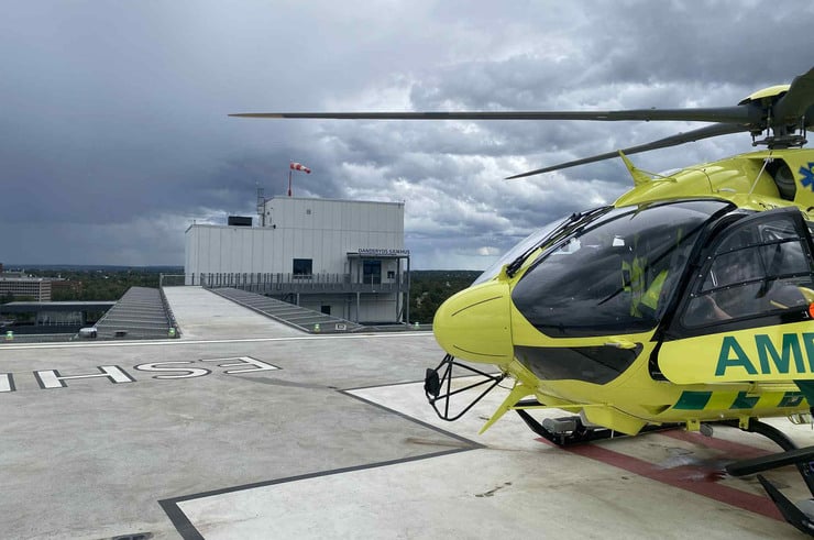 Helikopter står parkerad på helikopterflygplats vid Danderyds sjukhus.