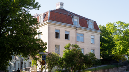 Byggnaden Lilla Hemmet med gul putsad fasad och rött tak.