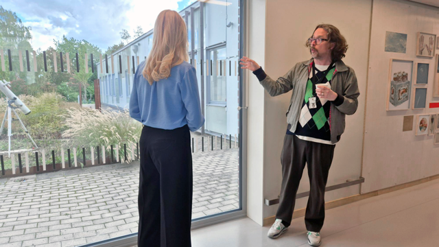 En man som berättar om konsten på Sollentuna sjukhus. Utomhuskonst i form av en kikare.
