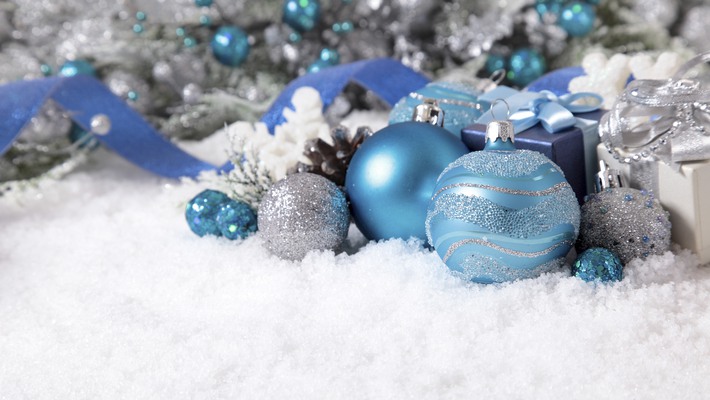 Christmas border with decorations and gifts on the snow. Space for copy.