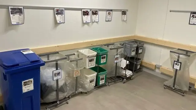 Utrymme med flera avfallskärl. 